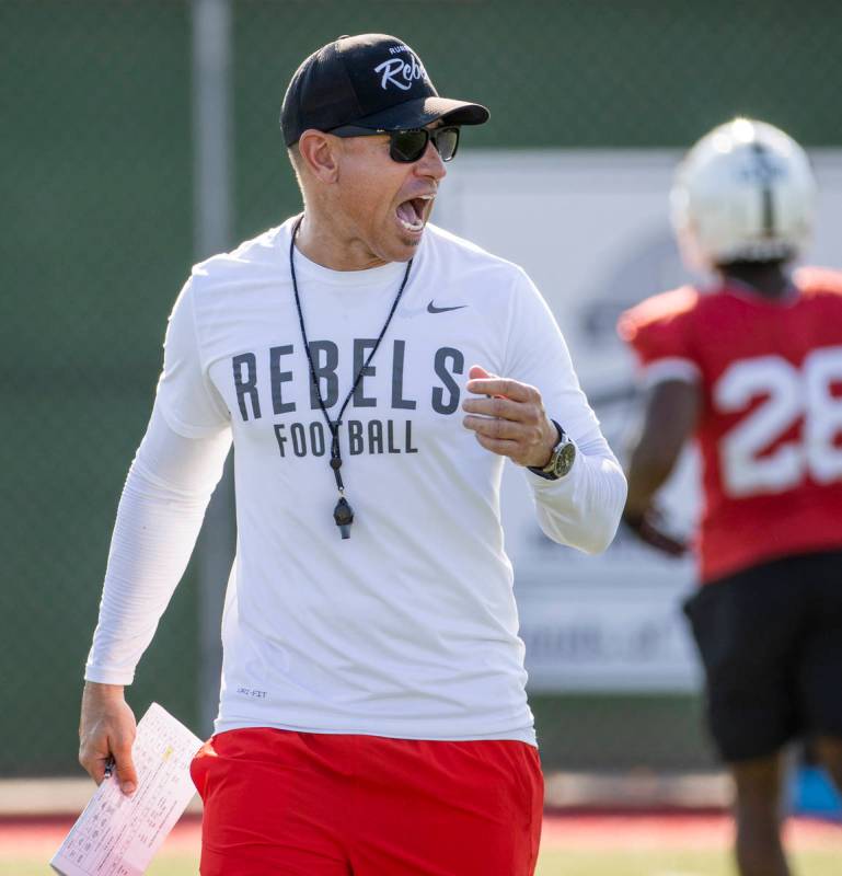 UNLV Head Coach Marcus Arroyo yells some encouragement to his players during a drill in footbal ...