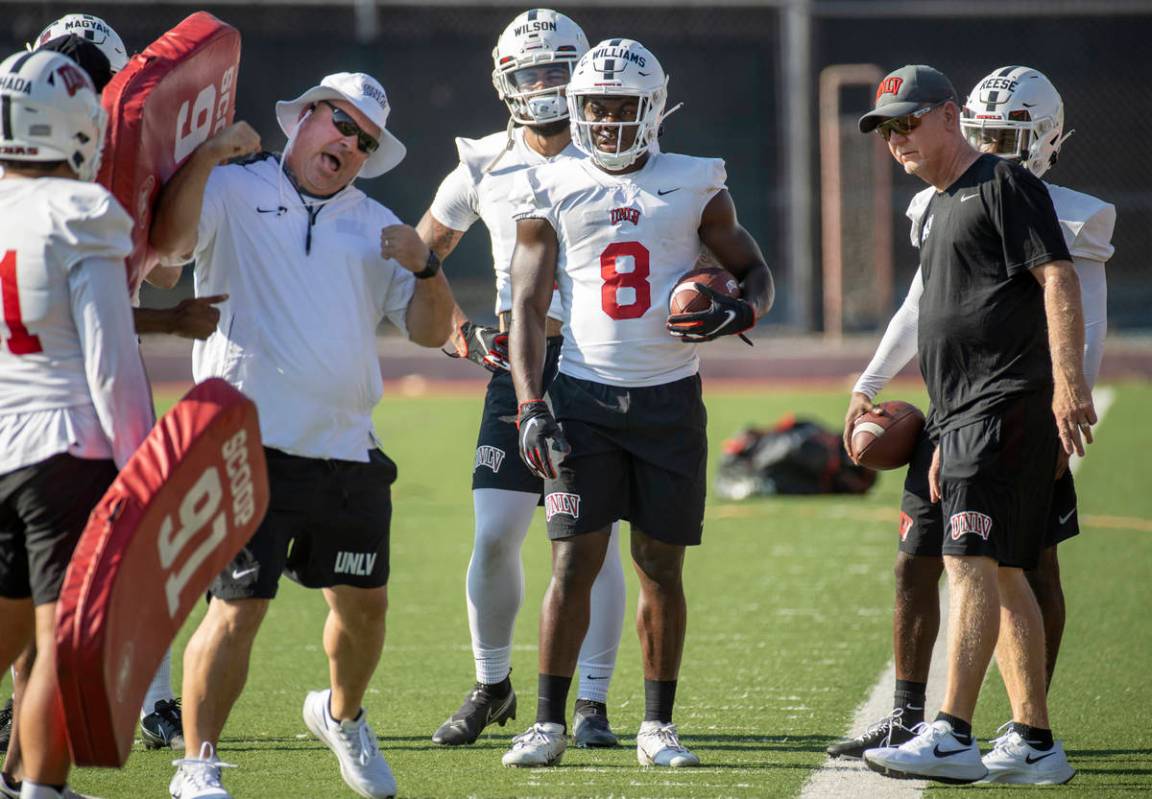 UNLV running back Charles Williams (8) watches as a coach explains a drill during football team ...