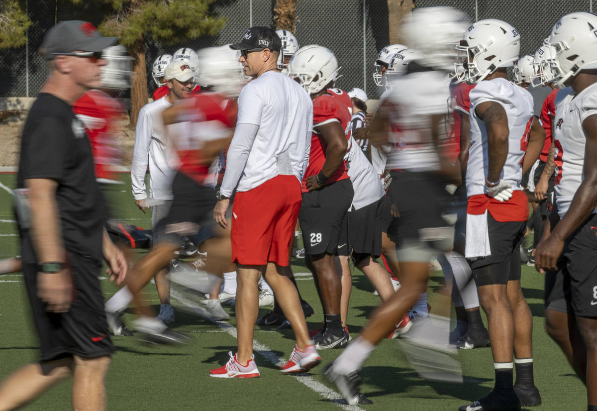 UNLV Head Coach Marcus Arroyo observes his players during a drill in football team practice at ...