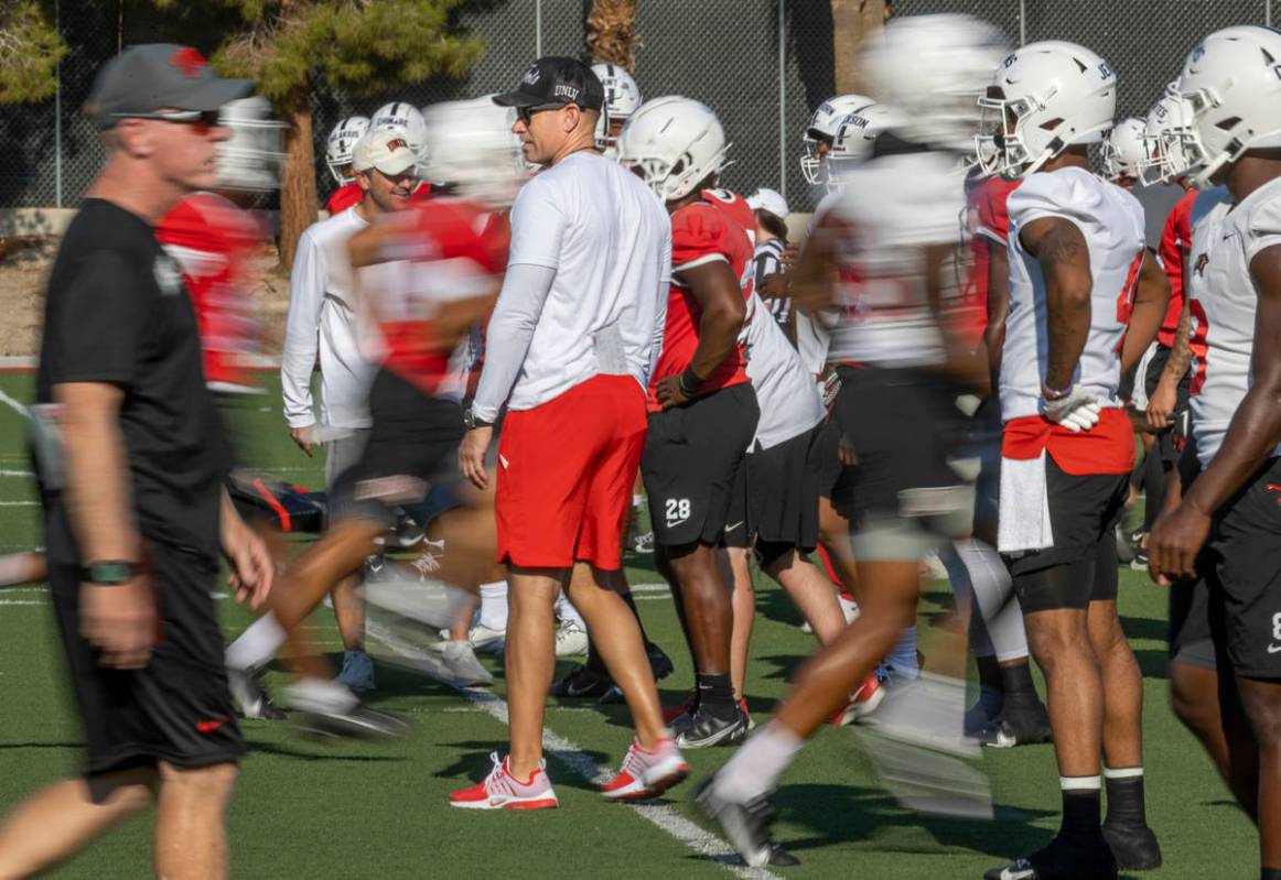 UNLV Head Coach Marcus Arroyo observes his players during a drill in football team practice at ...