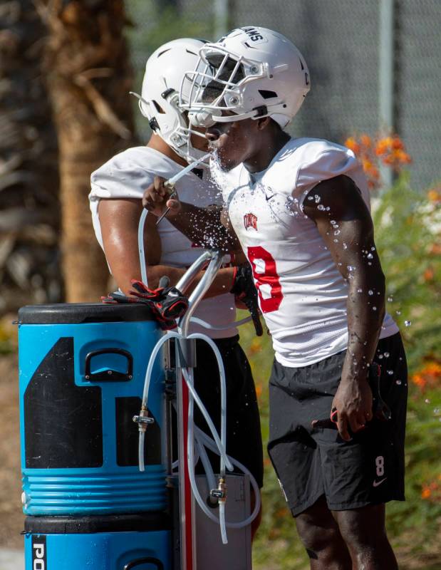 UNLV running back Charles Williams (8) hydrates during football team practice at Rebel Park on ...