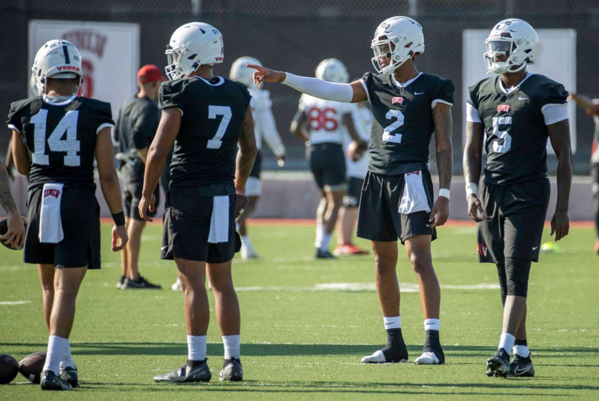 UNLV quarterbacks Jared Haywood (14), Cameron Friel (7), Doug Brumfield (2) and Justin Rogers ( ...