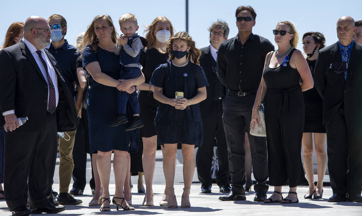 Family members watch as Nevada Highway Patrol trooper Micah May's casket is moved into his memo ...