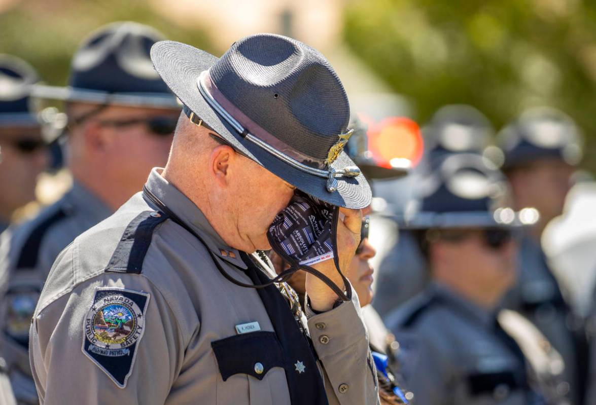 Capt. K. Honea wipes a tear during a graveside service at Palm Eastern Mortuary and Cemetery on ...