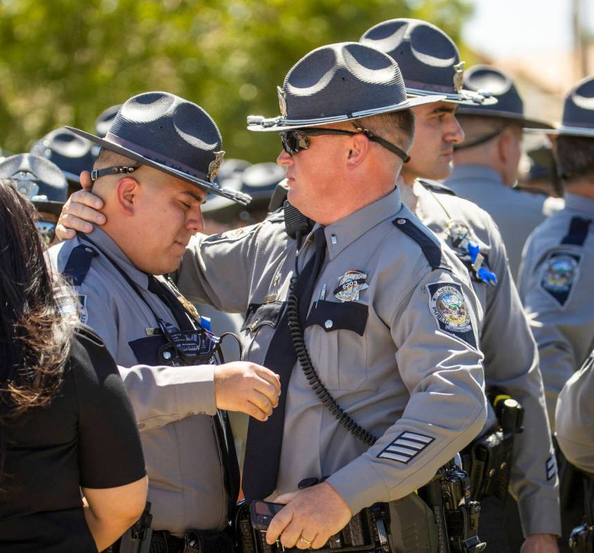 Nevada Highway Patrol troopers comfort each other during a graveside service at Palm Eastern Mo ...