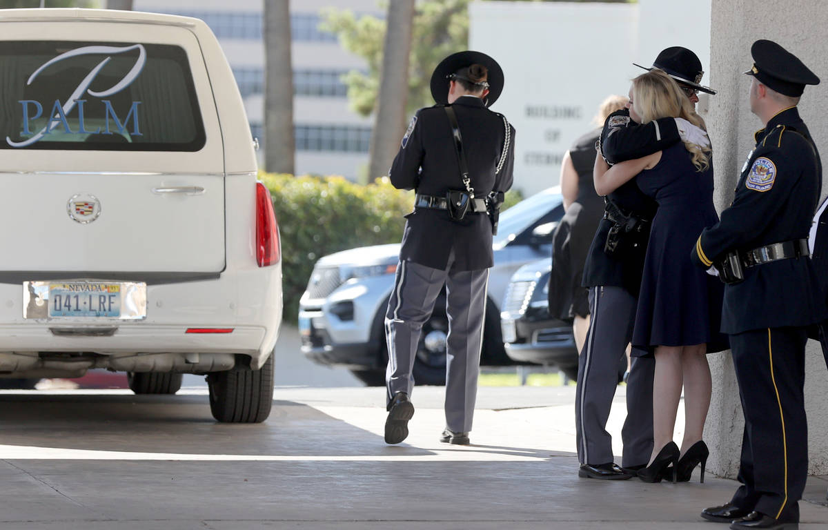 Joanna May, wife of fallen Nevada Highway Patrol trooper Micah May hugs a member of the Nevada ...