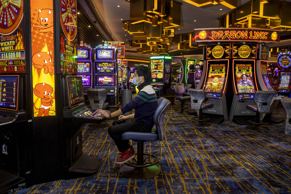 Zaw Naw of Denver plays the Hot Stuff Wicked Wheel slots on the casino floor at the Strat on We ...