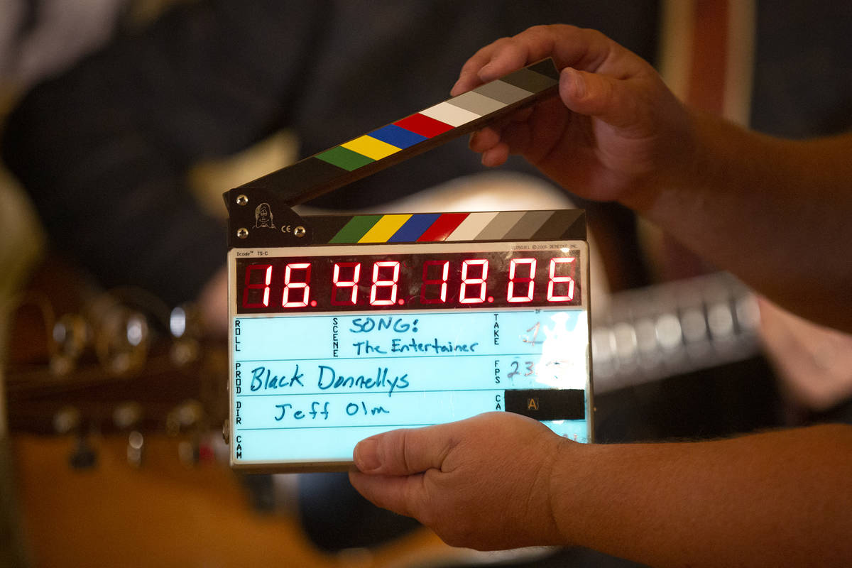 Producer Jeff Olm cuts the slate board while filming a documentary for The Black Donnellys, a l ...