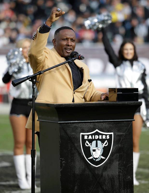 Former Oakland Raiders wide receiver Tim Brown gestures while speaking at a ceremony honoring h ...