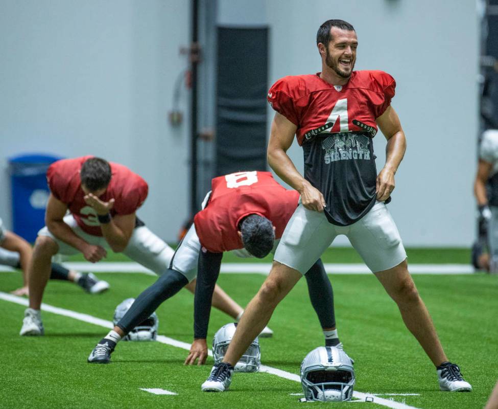 Raiders quarterback Derek Carr (4) laughs with teammates during practice at the Intermountain H ...