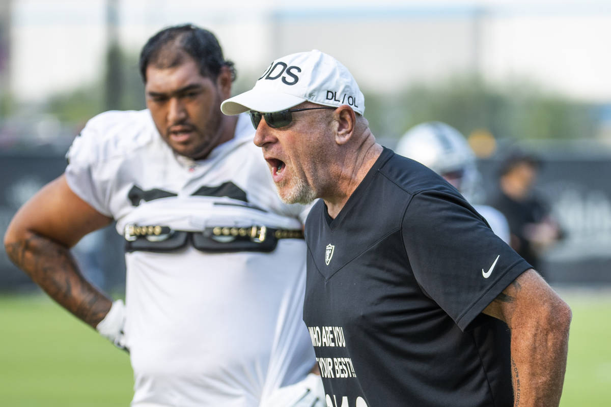 Raiders offensive line coach Tom Cable gives instructions to his players during practice at the ...