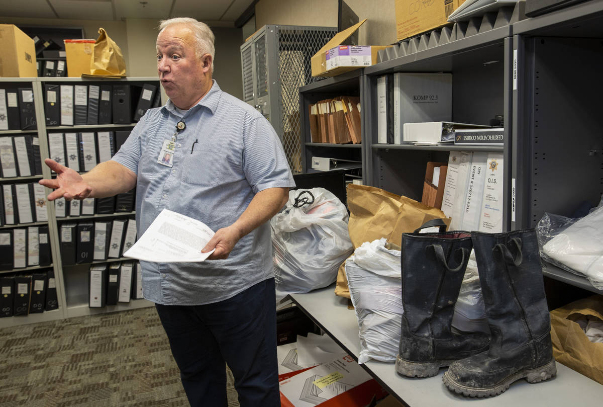 Metro Cold Case Detective Kenneth Hefner amongst the many binders of cold cases and other items ...