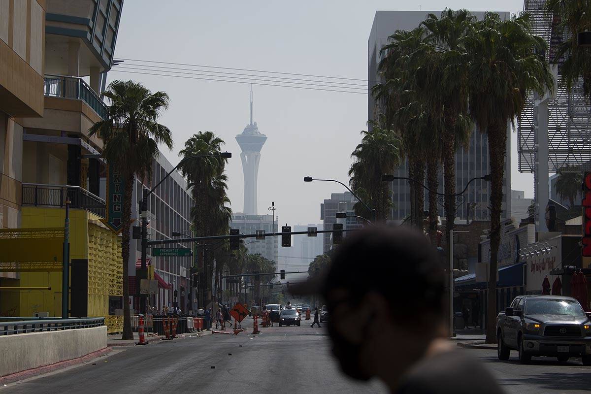 A pedestrian crosses North 4th Street while the STRAT is clouded by smoky skies on Saturday, Au ...