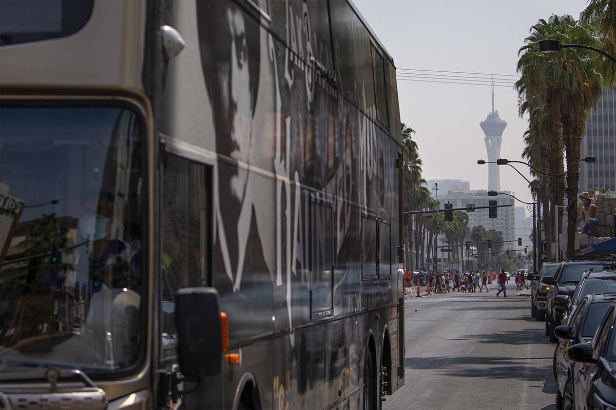 An RTC bus travels on North 4th Street while the STRAT is clouded by smoky skies on Saturday, A ...