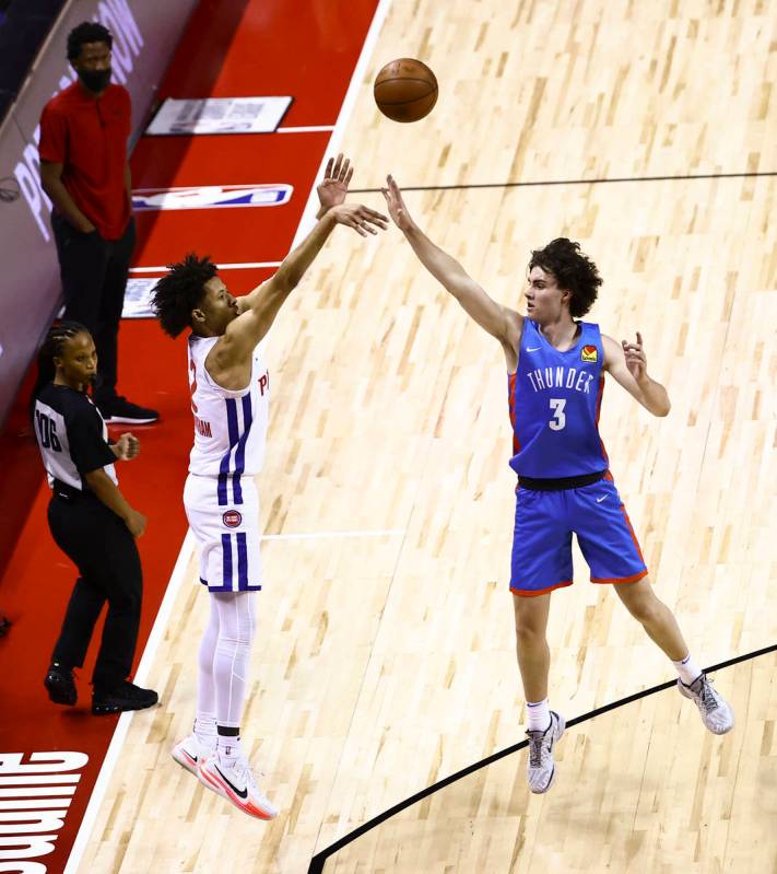 Detroit's Cade Cunningham, left, shoots over Oklahoma City's Josh Giddey (3) during the first h ...