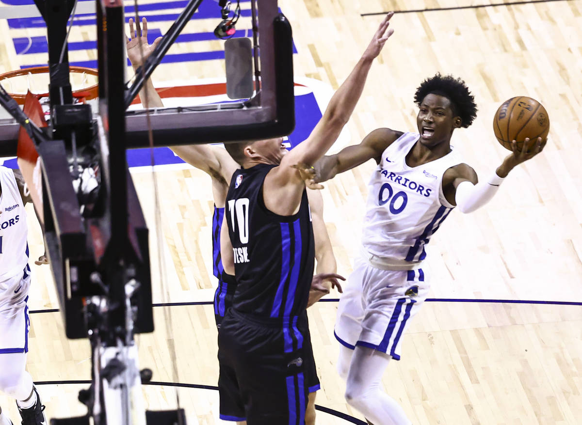 Orlando's Jon Teske (70) defends as Golden State's Jonathan Kuminga (00) attempts to score duri ...