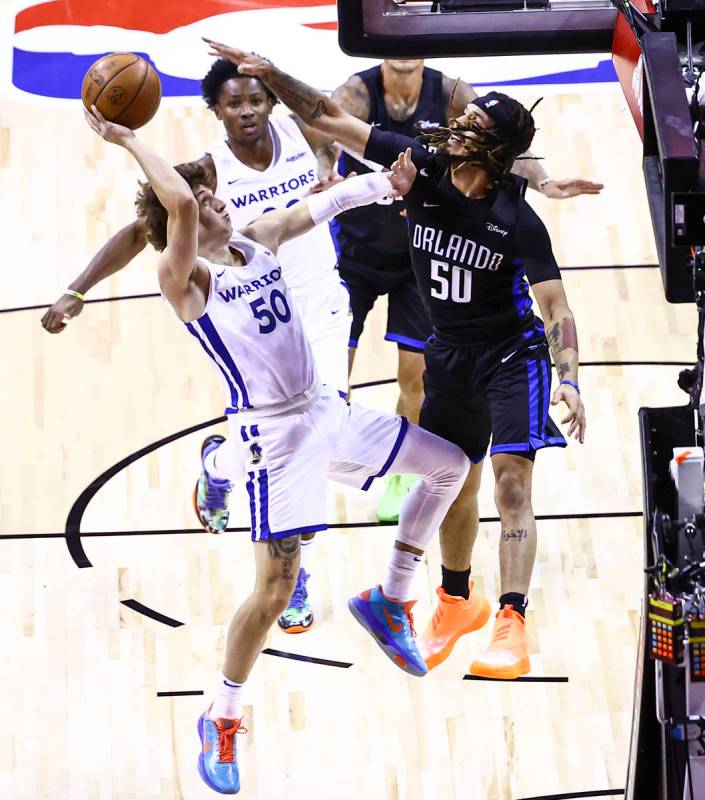 Orlando's Cole Anthony (50), right, blocks Golden State's Kyle Guy (50) as he lays up the ball ...