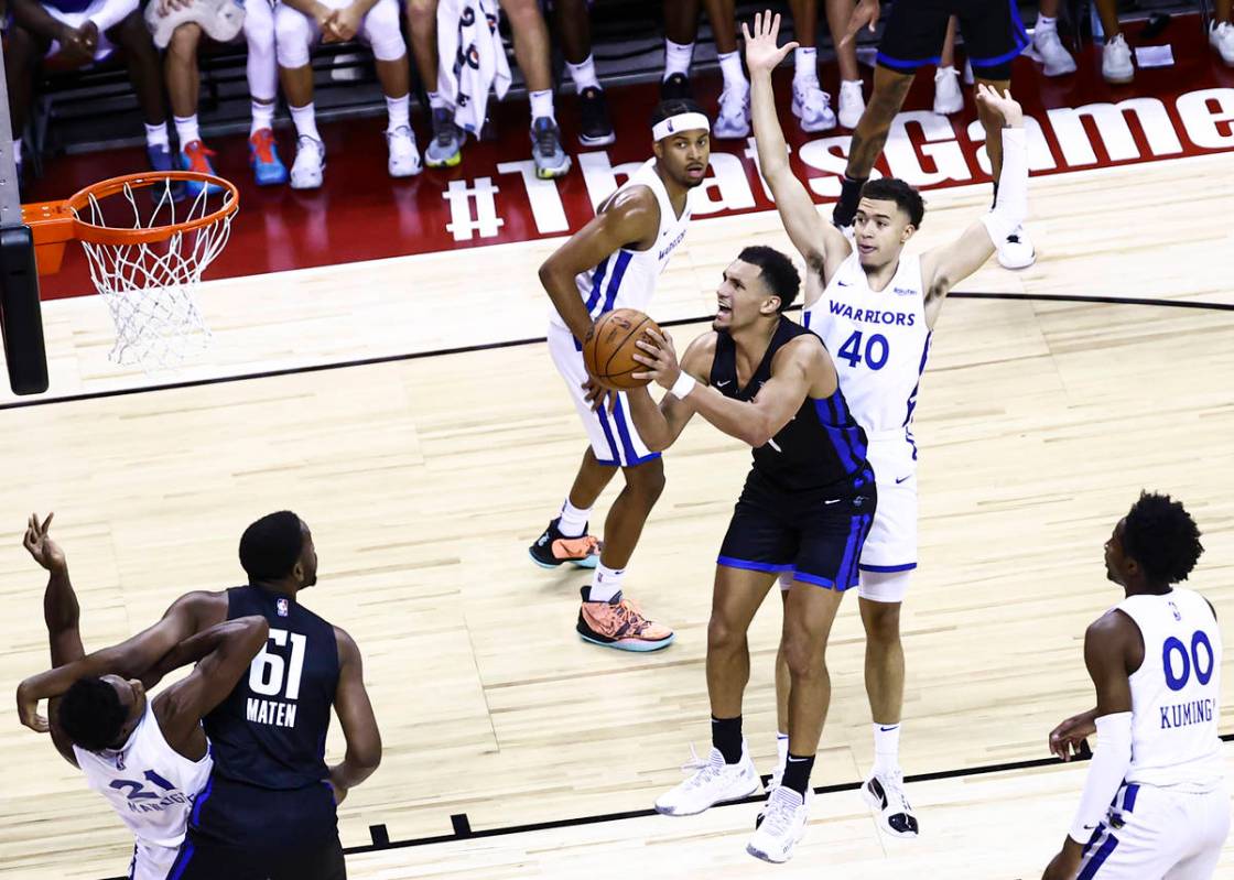 Orlando's Jalen Suggs (4) looks to shoot in front of Golden State's Jaquori McLaughlin (40) dur ...