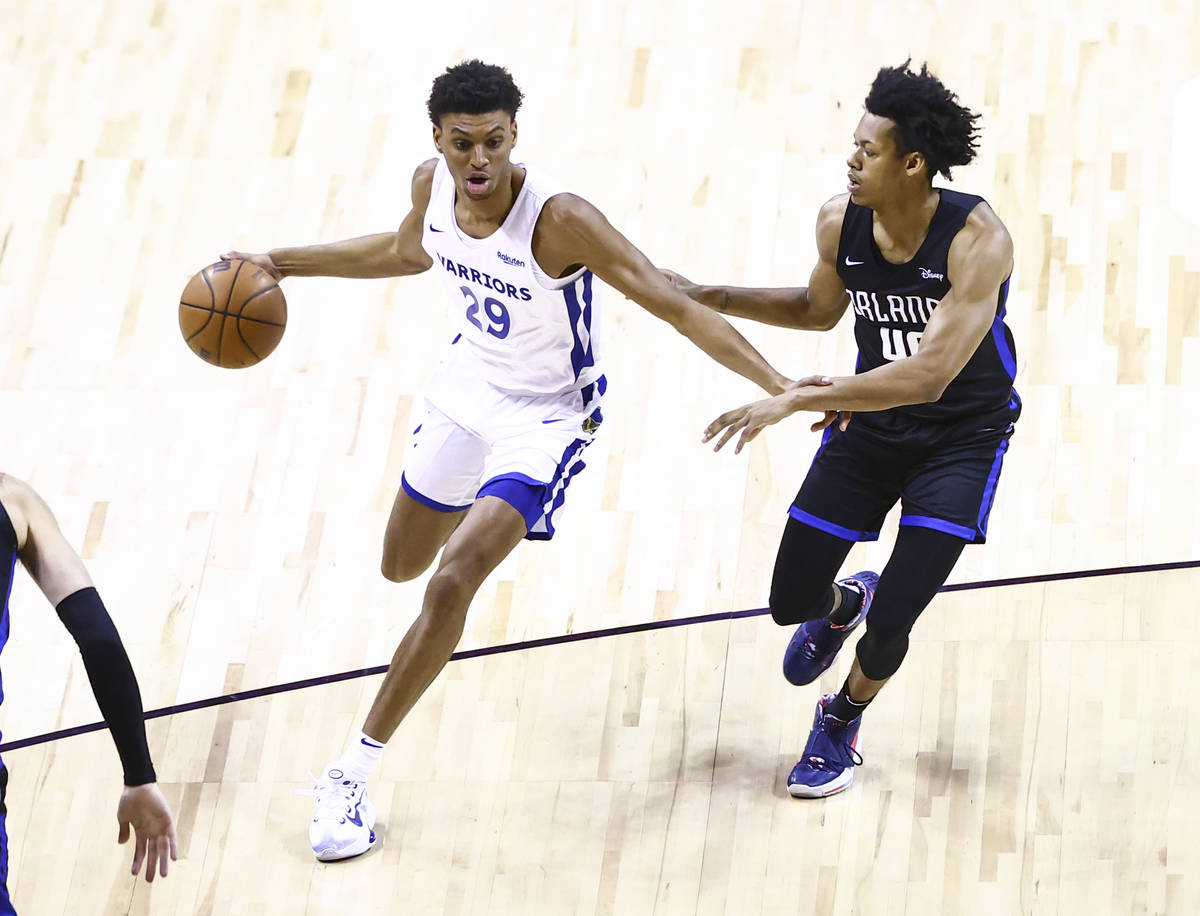 Golden State's Derrick Alston Jr. (29) drives the ball around Orlando's Jeff Dowtin (40) agains ...