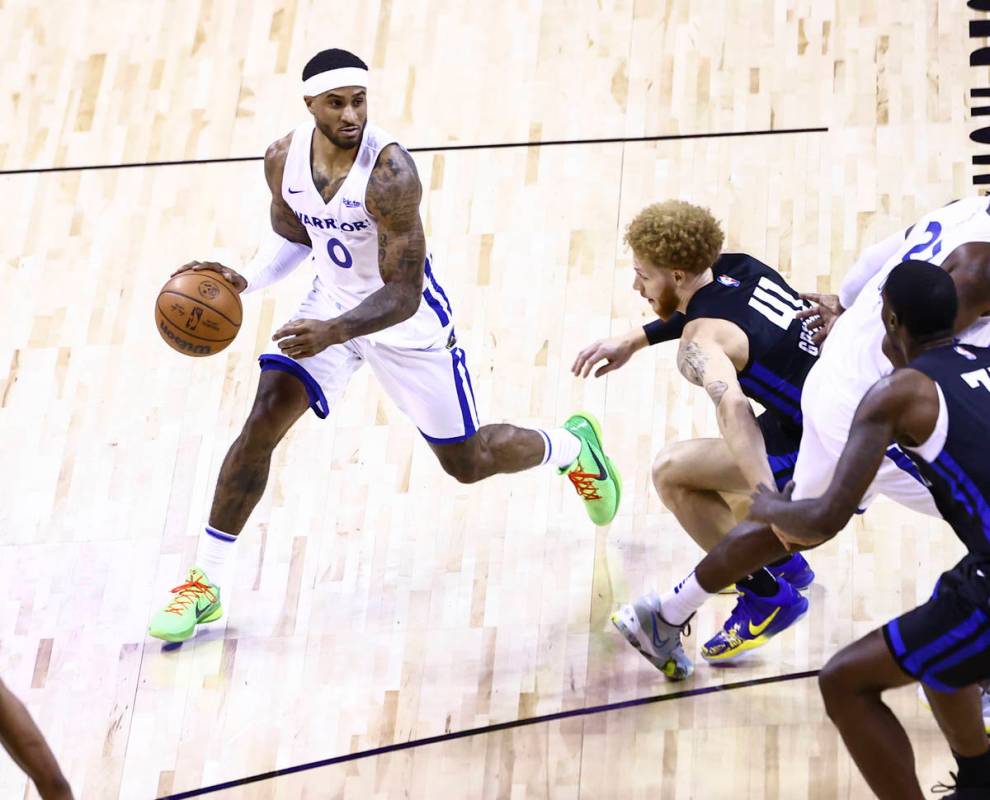 Golden State's Gary Payton II (0) drives the ball around Orlando's Hassani Gravett (41) during ...