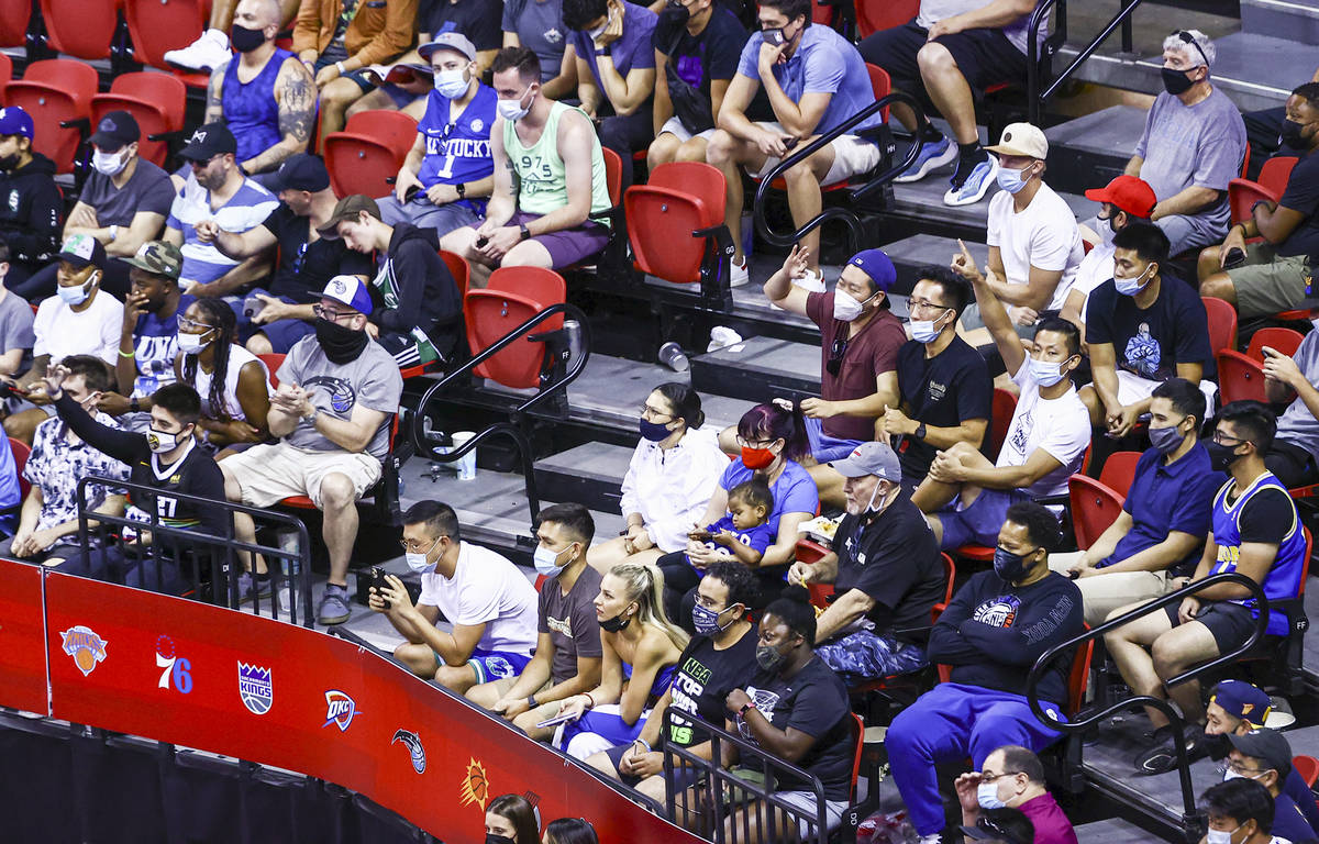 Basketball fans celebrate after a three-pointer from Orlando Magic during the second half of an ...