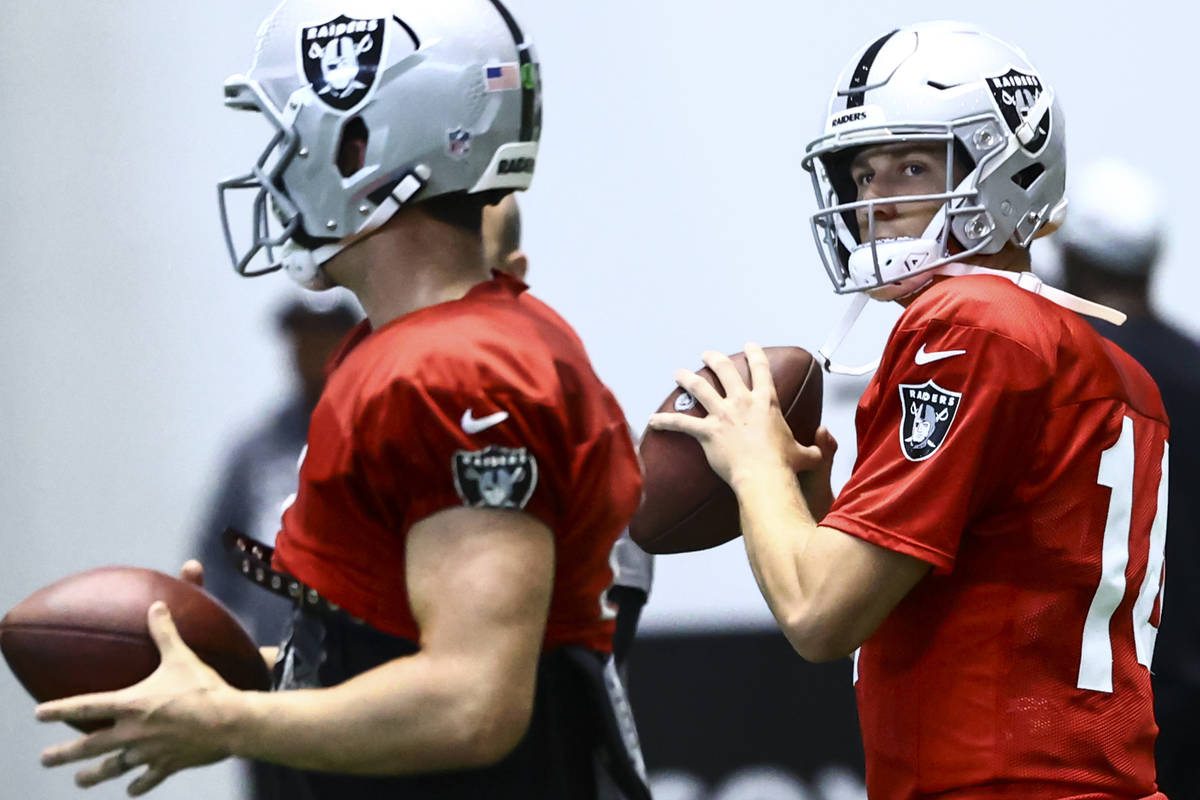 Raiders quarterback Case Cookus looks to throw a pass during training camp at Raiders Headquart ...