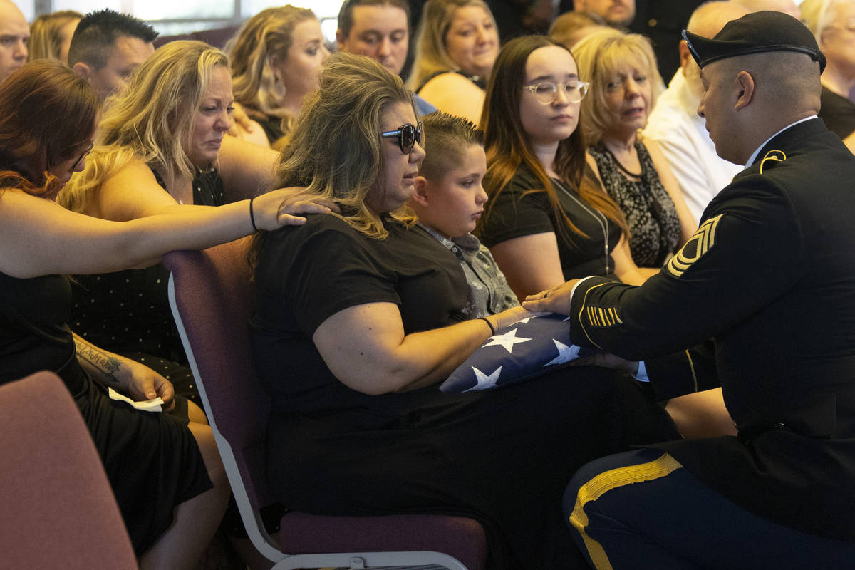 In this July 8, 2021, file photo, U.S. Army Master Sgt. Rafael Aguilera, right, presents the Am ...