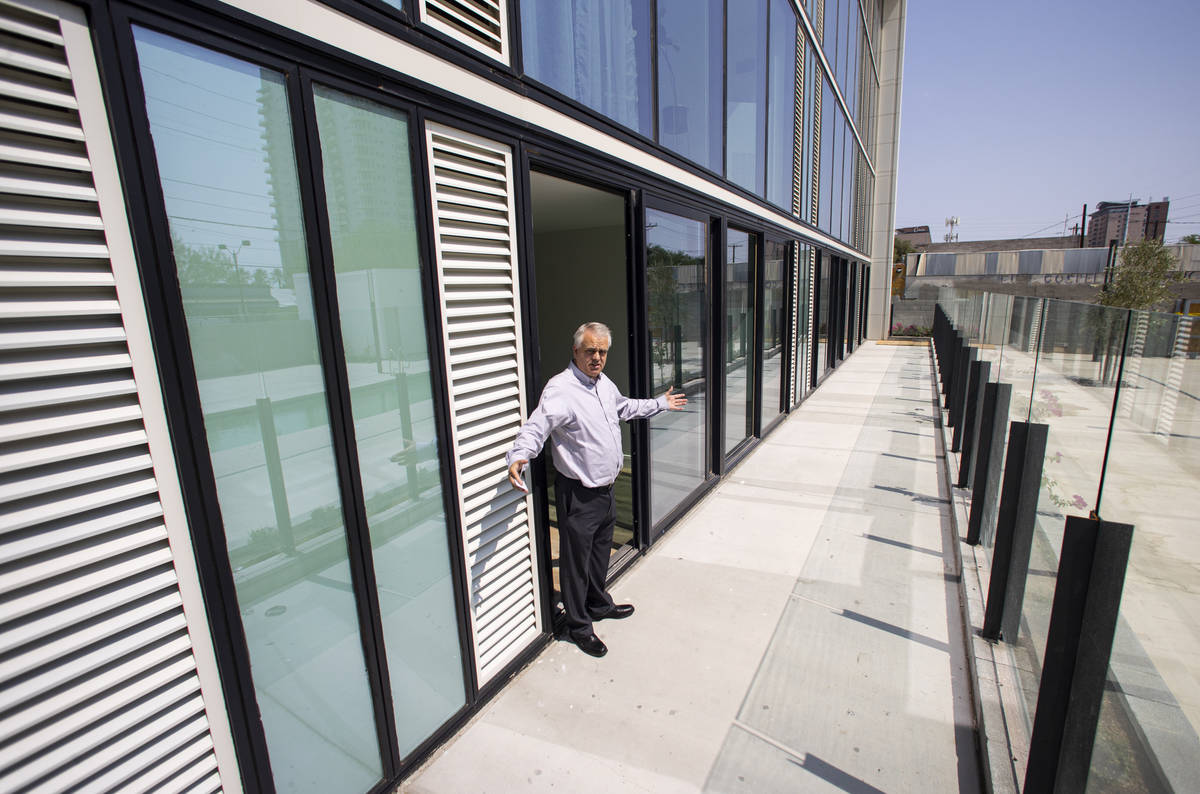 Steve Dennis, general manager of The English Hotel, shows private patio spaces by the pool duri ...