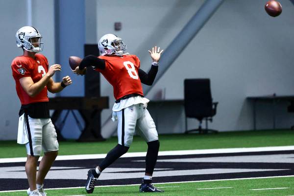 Raiders quarterback Marcus Mariota (8) looks to throw a pass alongside quarterback Nathan Peter ...
