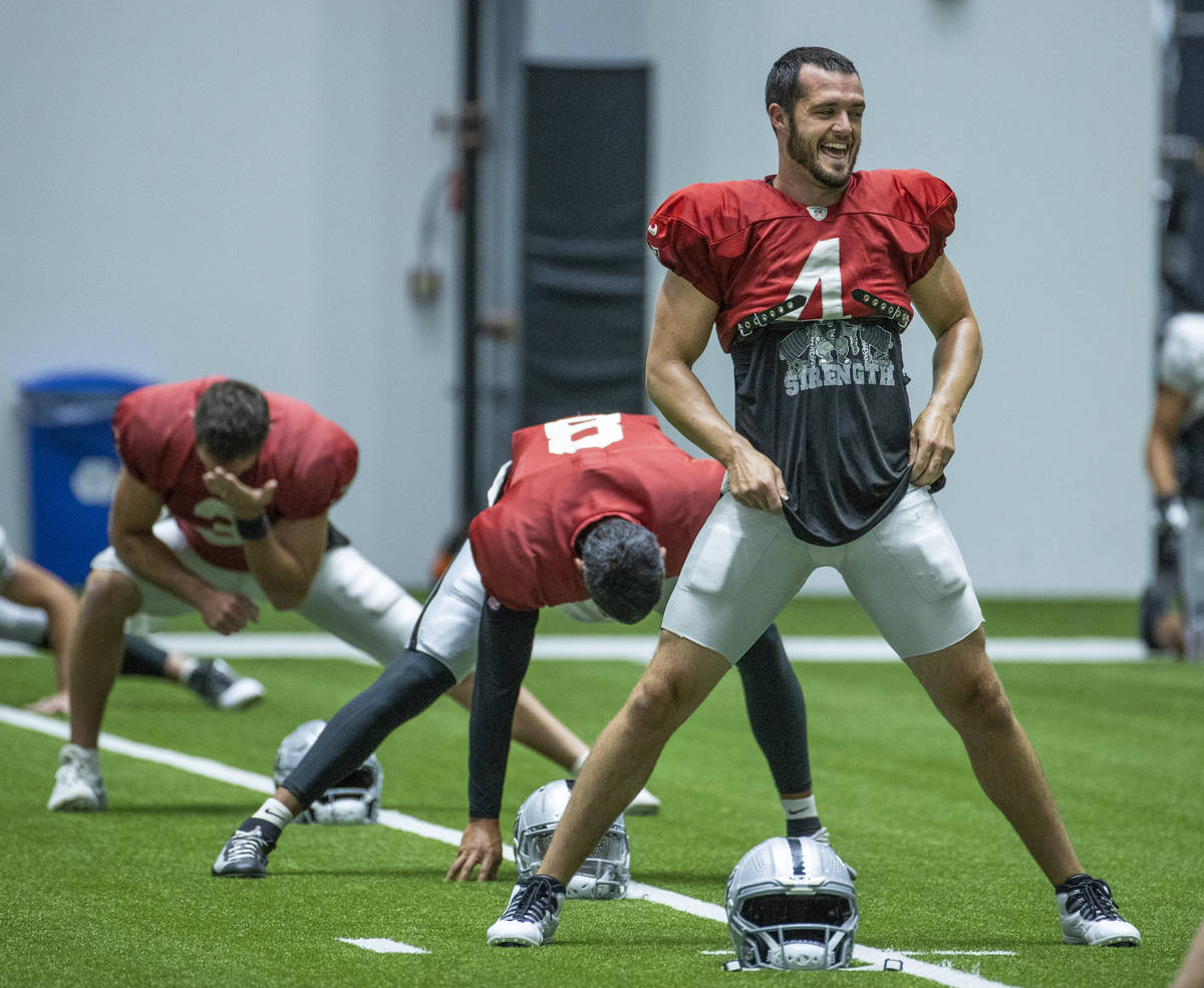 Raiders quarterback Derek Carr (4) laughs with teammates during practice at the Intermountain H ...