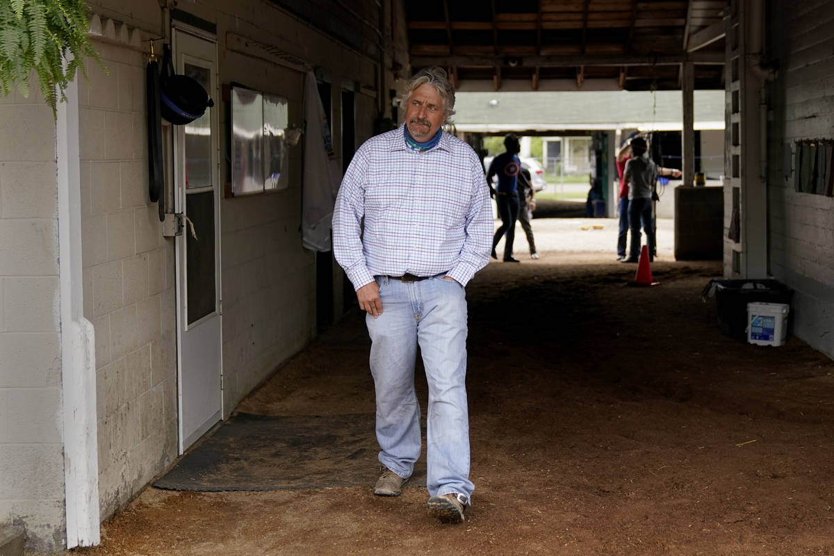 Trainer Steve Asmussen looks out from his barn after a workout at Churchill Downs Wednesday, Ap ...