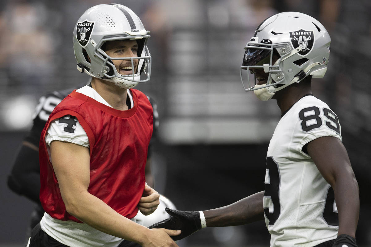 Raiders quarterback Derek Carr (4) and Raiders wide receiver Bryan Edwards (89) celebrate a big ...