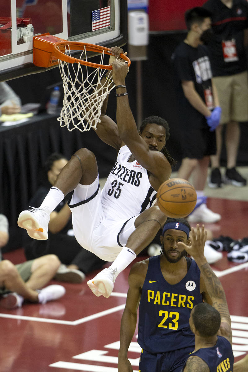 Portland Trail Blazers forward Kenneth Faried (35) dunks above Indiana Pacers forward Isaiah Ja ...