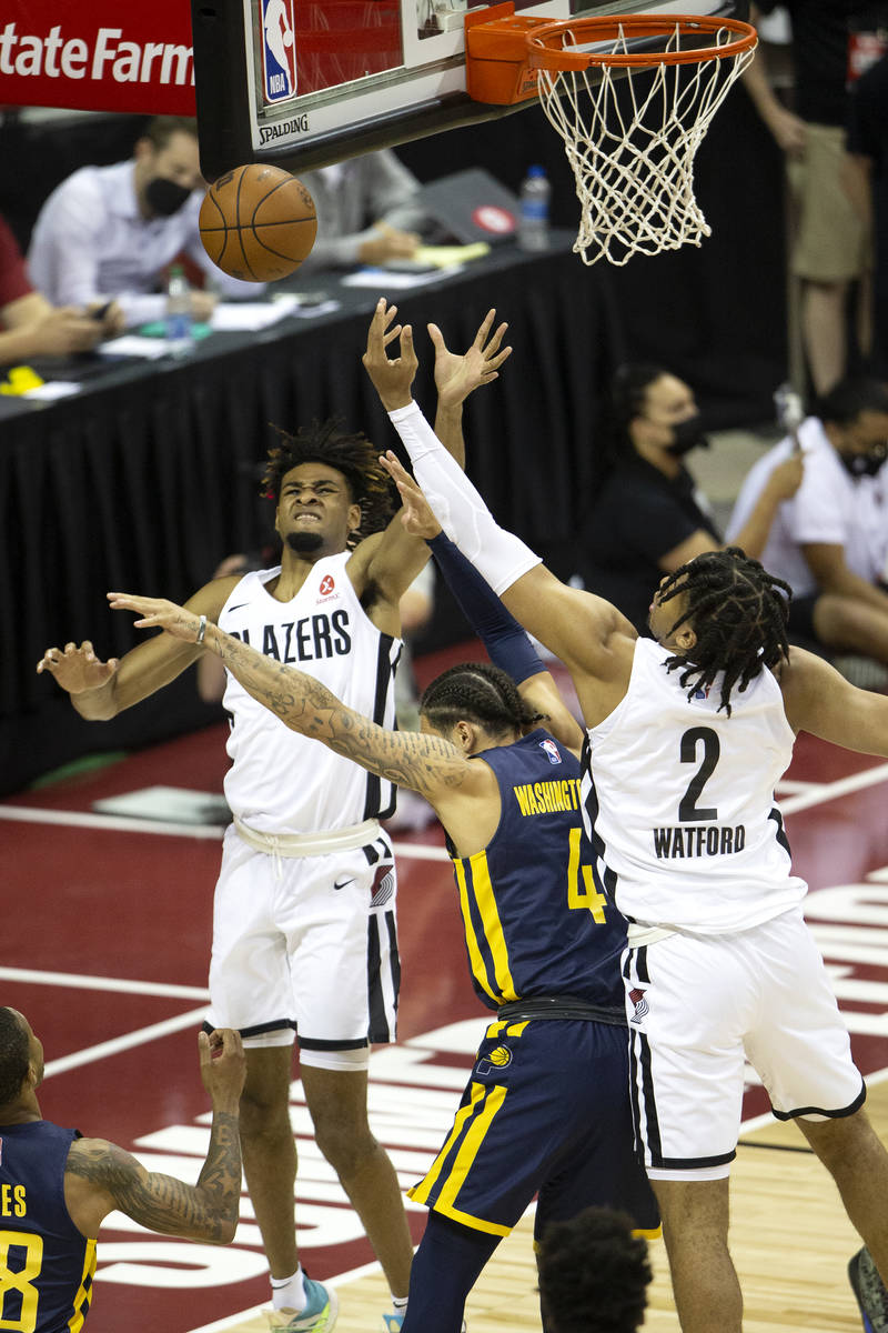 Portland Trail Blazers forward Greg Brown III, behind, and forward Trendon Watford (2) attempt ...