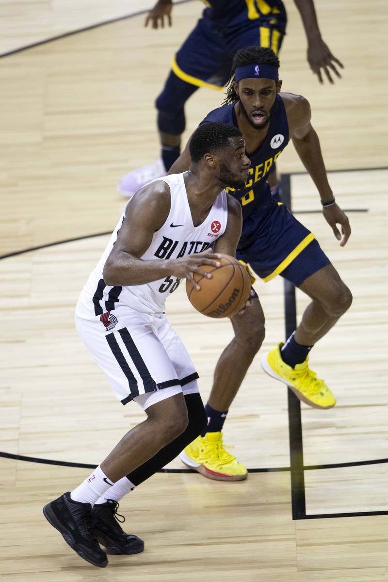 Portland Trail Blazers guard Emmanuel Mudiay (58) dribbles around Indiana Pacers forward Isaiah ...