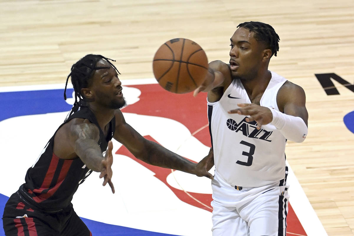 Utah Jazz guard Trent Forrest (3) passes the ball away from Miami Heat guard Marcus Garrett dur ...