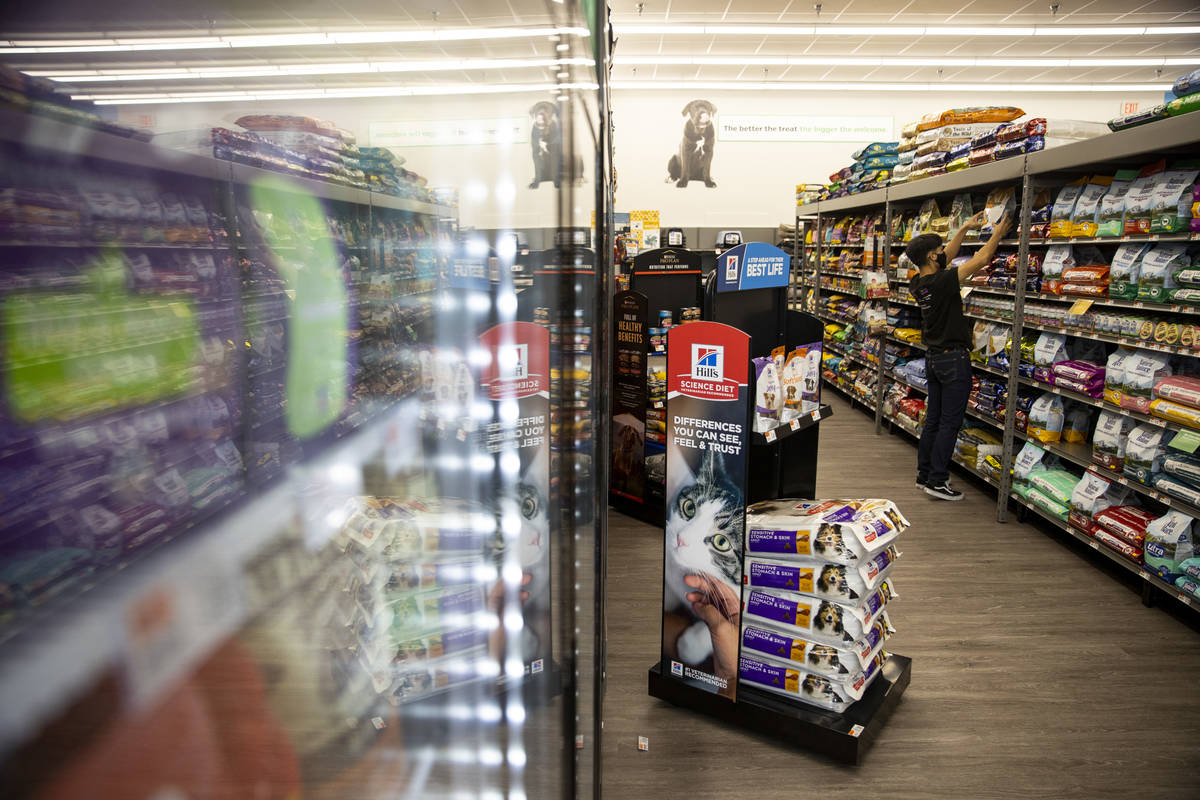 Team member Kevin Aumentado organizes the shelves at Pet Supplies Plus, owned by local entrepre ...