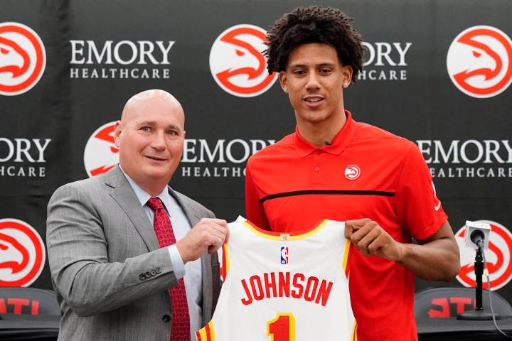 Atlanta Hawks NBA basketball draft pick Jalen Johnson, right, and Hawks general manger Travis S ...