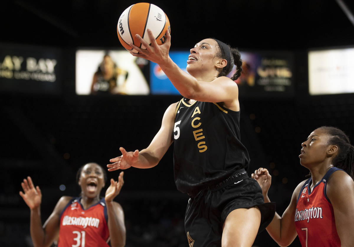 Las Vegas Aces forward Dearica Hamby (5) drives past Washington Mystics center Tina Charles (31 ...