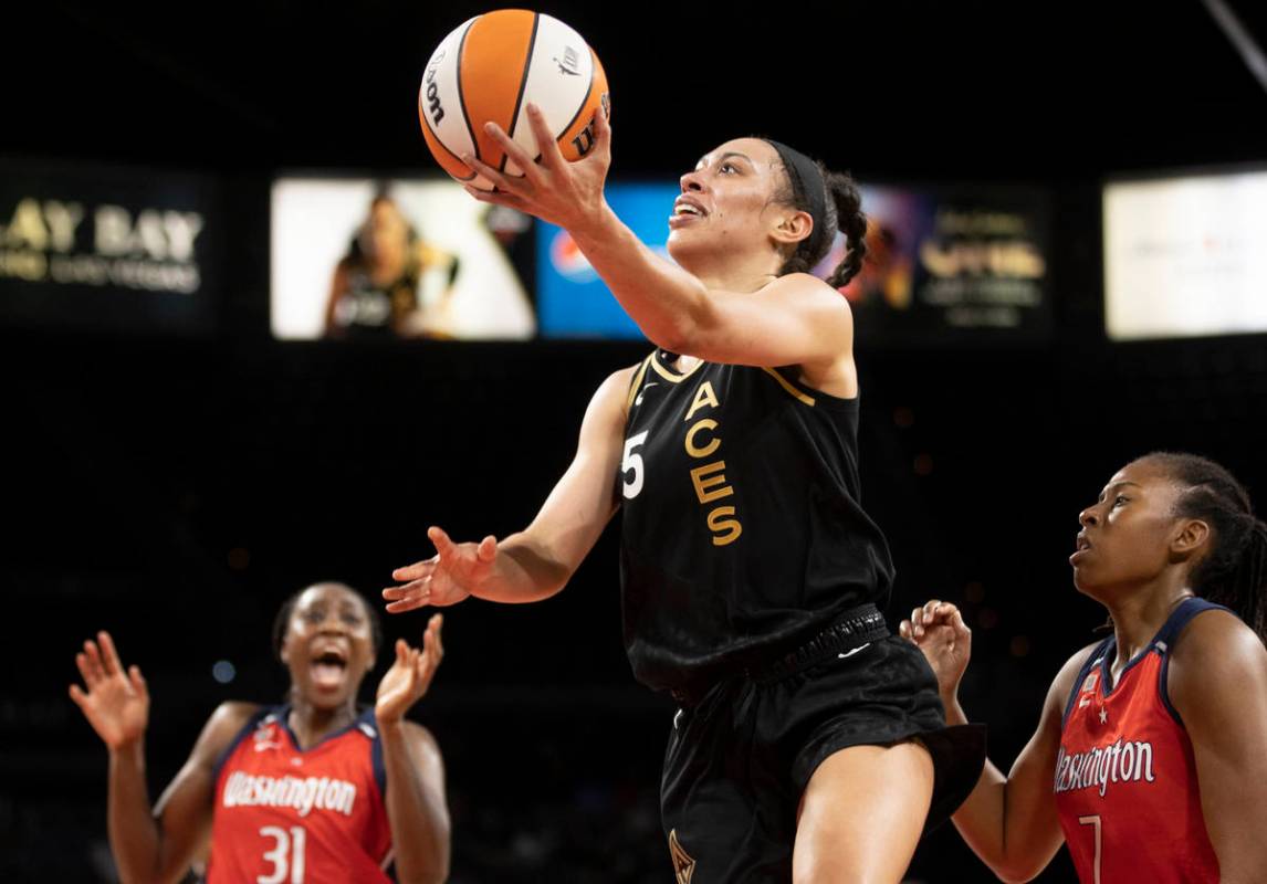 Las Vegas Aces forward Dearica Hamby (5) drives past Washington Mystics center Tina Charles (31 ...