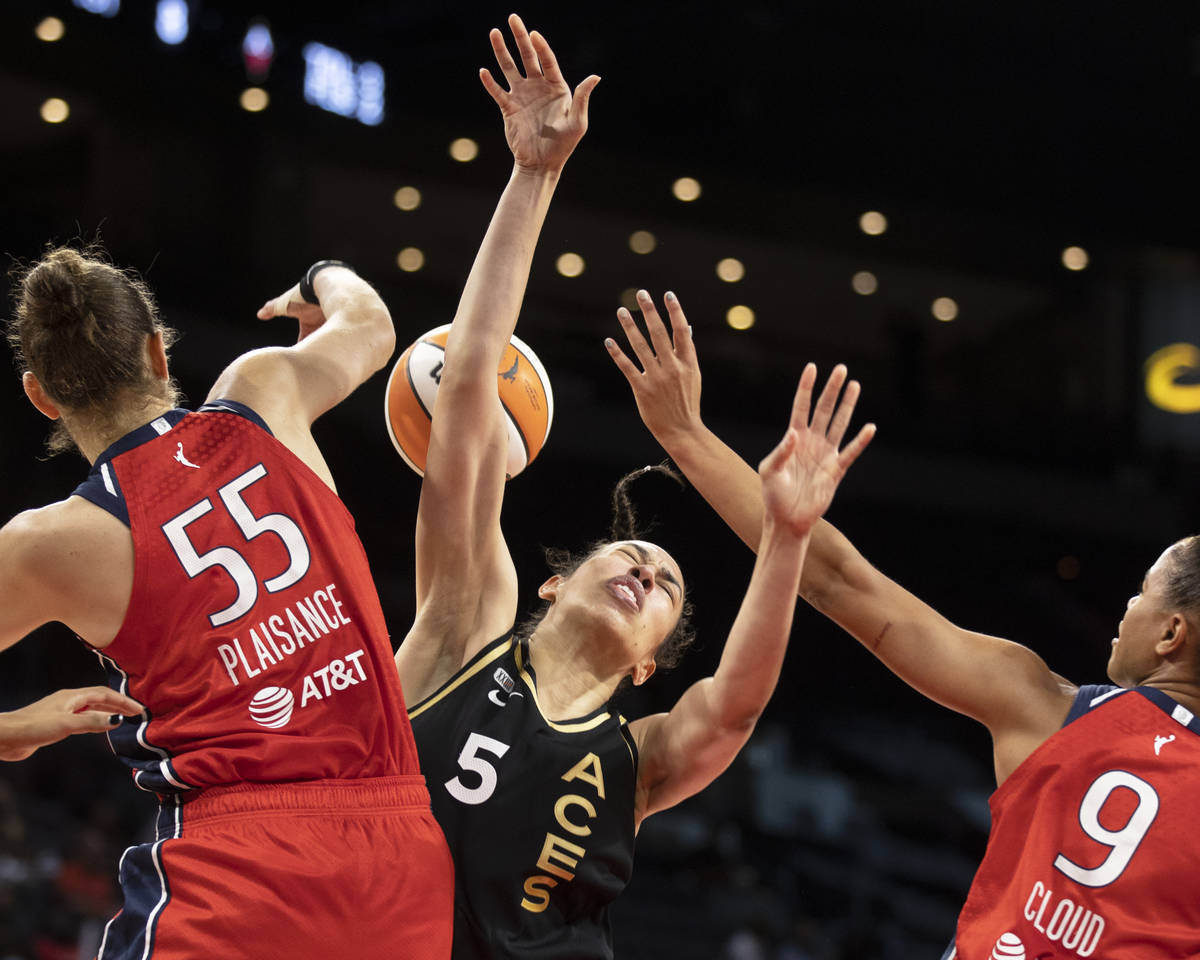 Las Vegas Aces forward Dearica Hamby (5) is fouled by Washington Mystics forward Theresa Plaisa ...