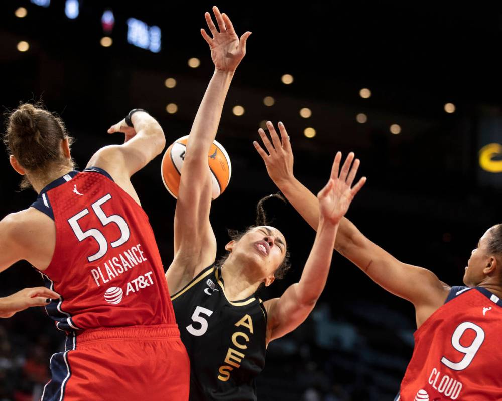 Las Vegas Aces forward Dearica Hamby (5) is fouled by Washington Mystics forward Theresa Plaisa ...