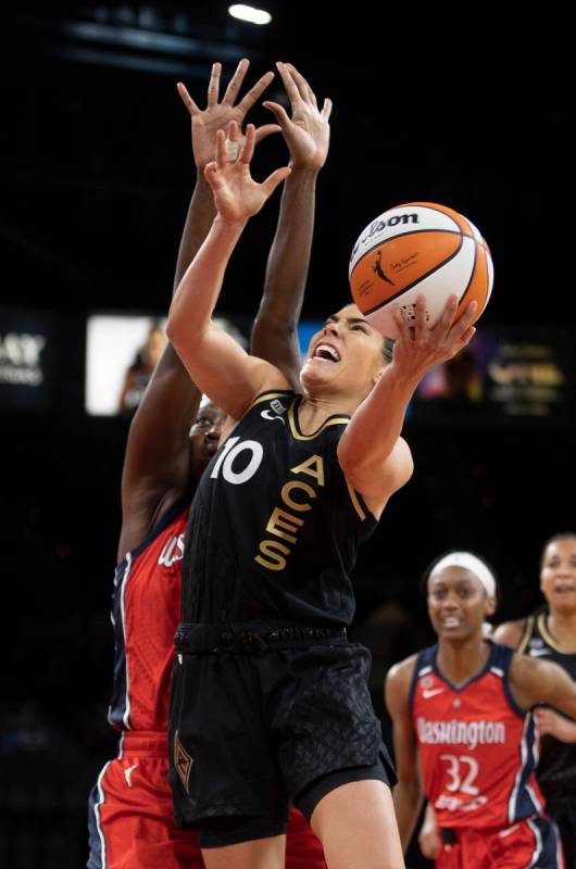 Las Vegas Aces guard Kelsey Plum (10) drives past Washington Mystics center Tina Charles (31) i ...