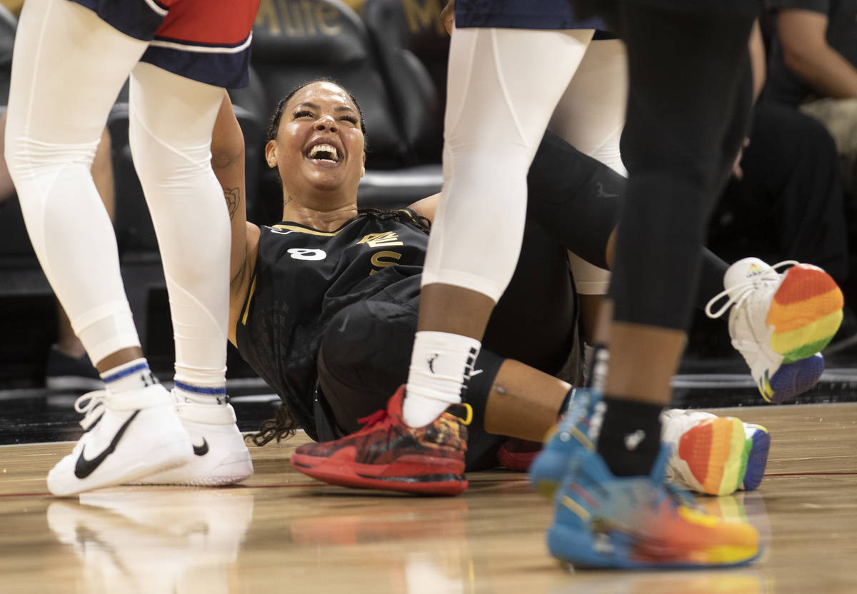 Las Vegas Aces center Liz Cambage (8) laughs after colliding with Washington Mystic’s pl ...