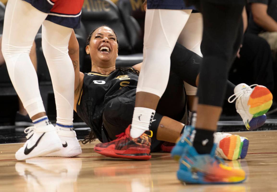 Las Vegas Aces center Liz Cambage (8) laughs after colliding with Washington Mystic’s pl ...