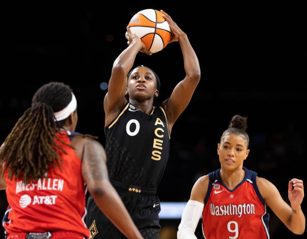 Las Vegas Aces guard Jackie Young (0) shoots over Washington Mystics guard Natasha Cloud (9) in ...