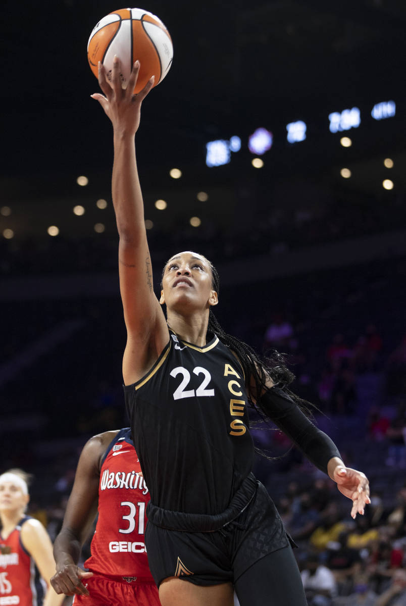 Las Vegas Aces forward A'ja Wilson (22) drives past Washington Mystics center Tina Charles (31) ...