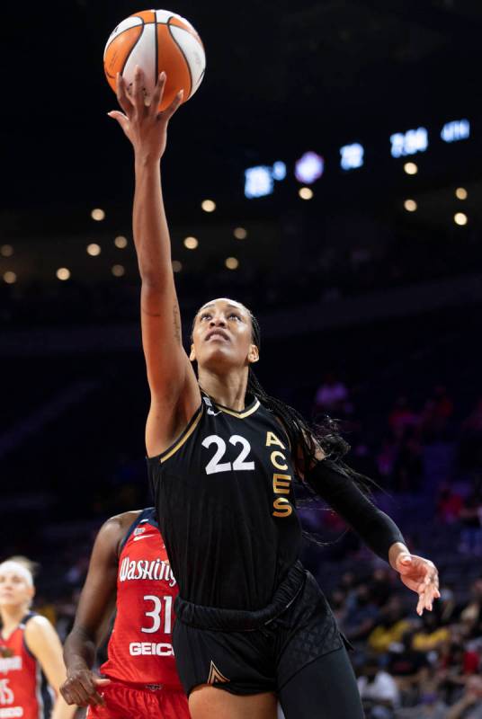 Las Vegas Aces forward A'ja Wilson (22) drives past Washington Mystics center Tina Charles (31) ...