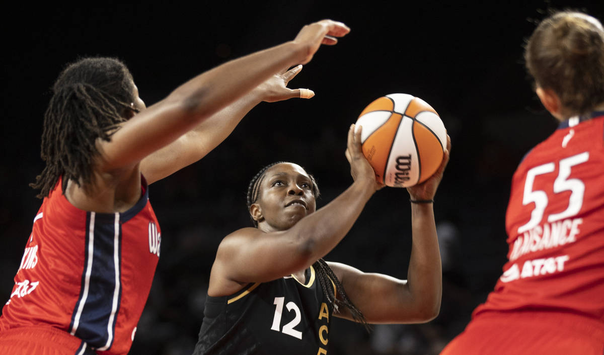 Las Vegas Aces guard Chelsea Gray (12) shoots over Washington Mystics forward Theresa Plaisance ...