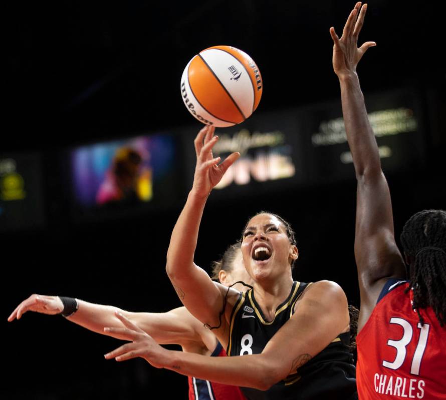 Las Vegas Aces center Liz Cambage (8) slices to the rim past Washington Mystics center Tina Cha ...